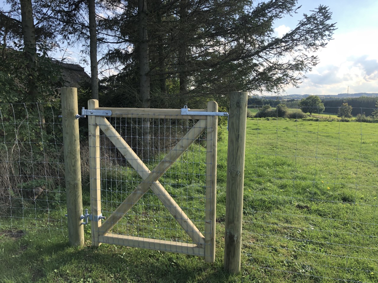 I tillägg till ett nätstängsel installeras en Country Estate-grind